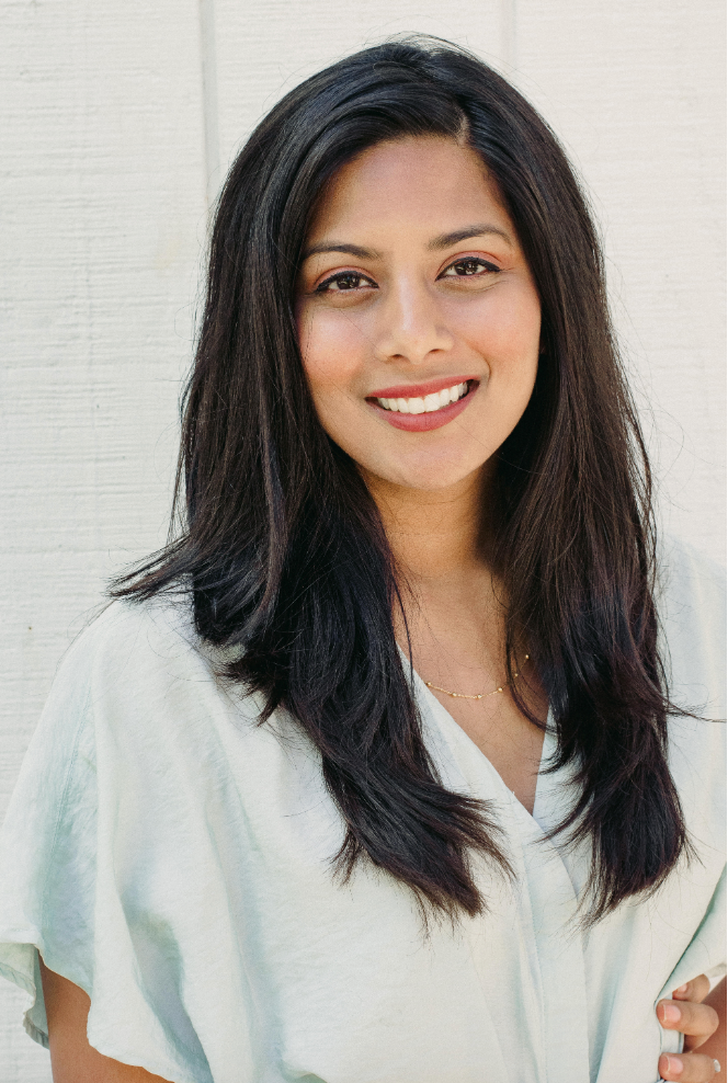 Photograph of Anita smiling against a white background